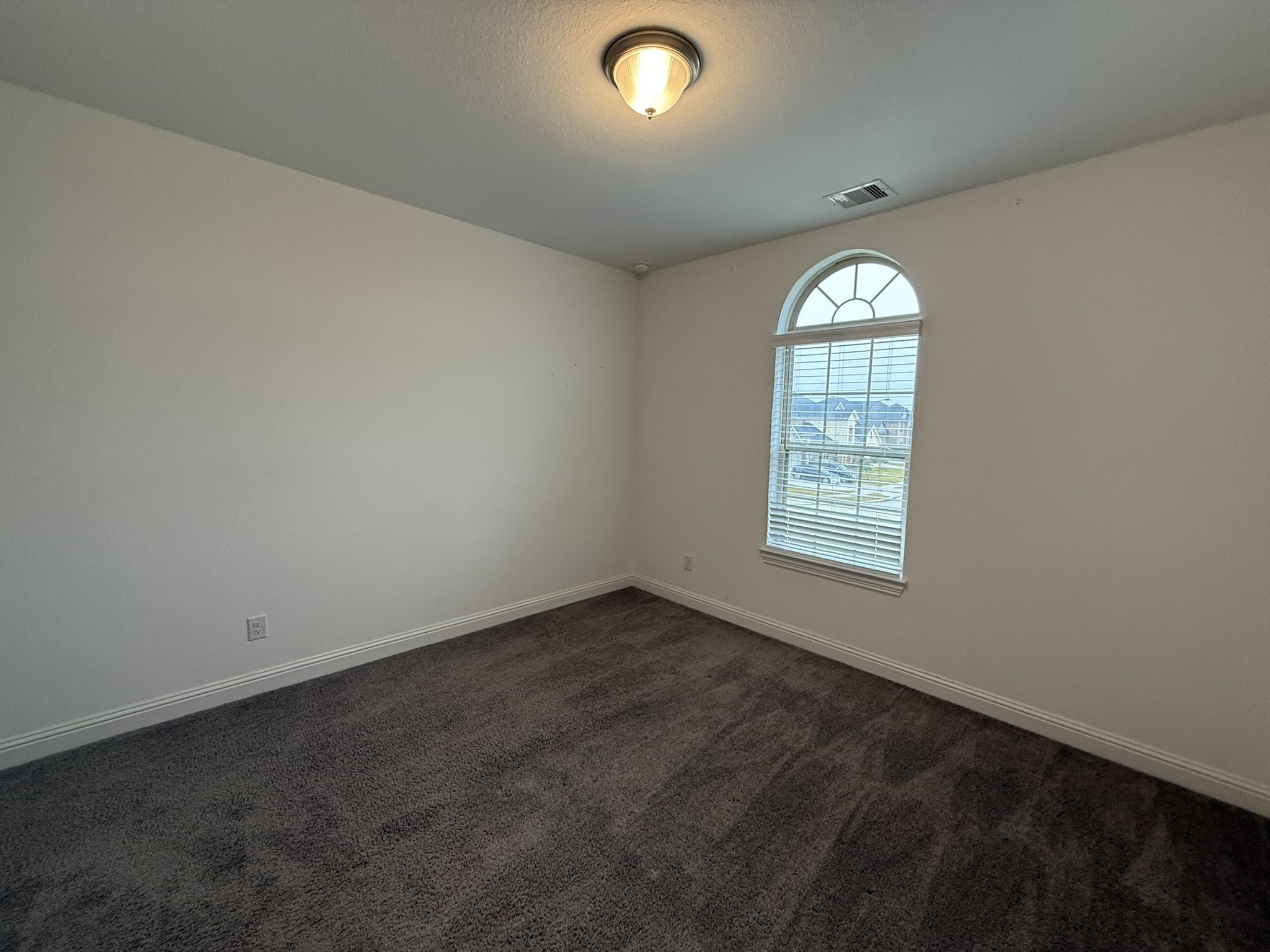 7802 Wayman Pass Fulshear, TX 77441 - Photo 42 of 50 an empty room with windows and closet