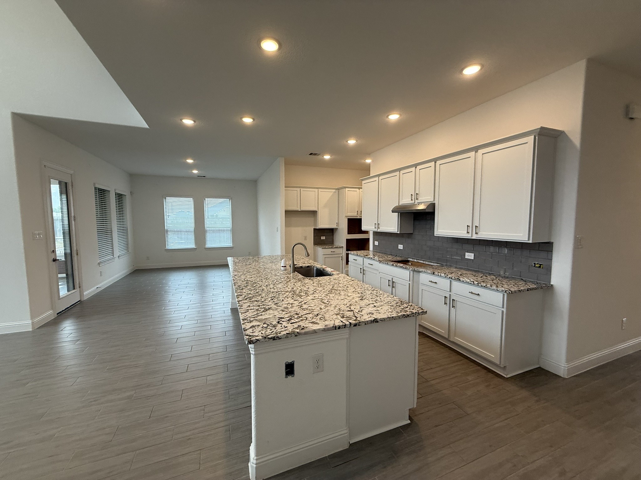 7802 Wayman Pass Fulshear, TX 77441 - Photo 8 of 50 a kitchen with stainless steel appliances granite countertop a sink and a stove top oven