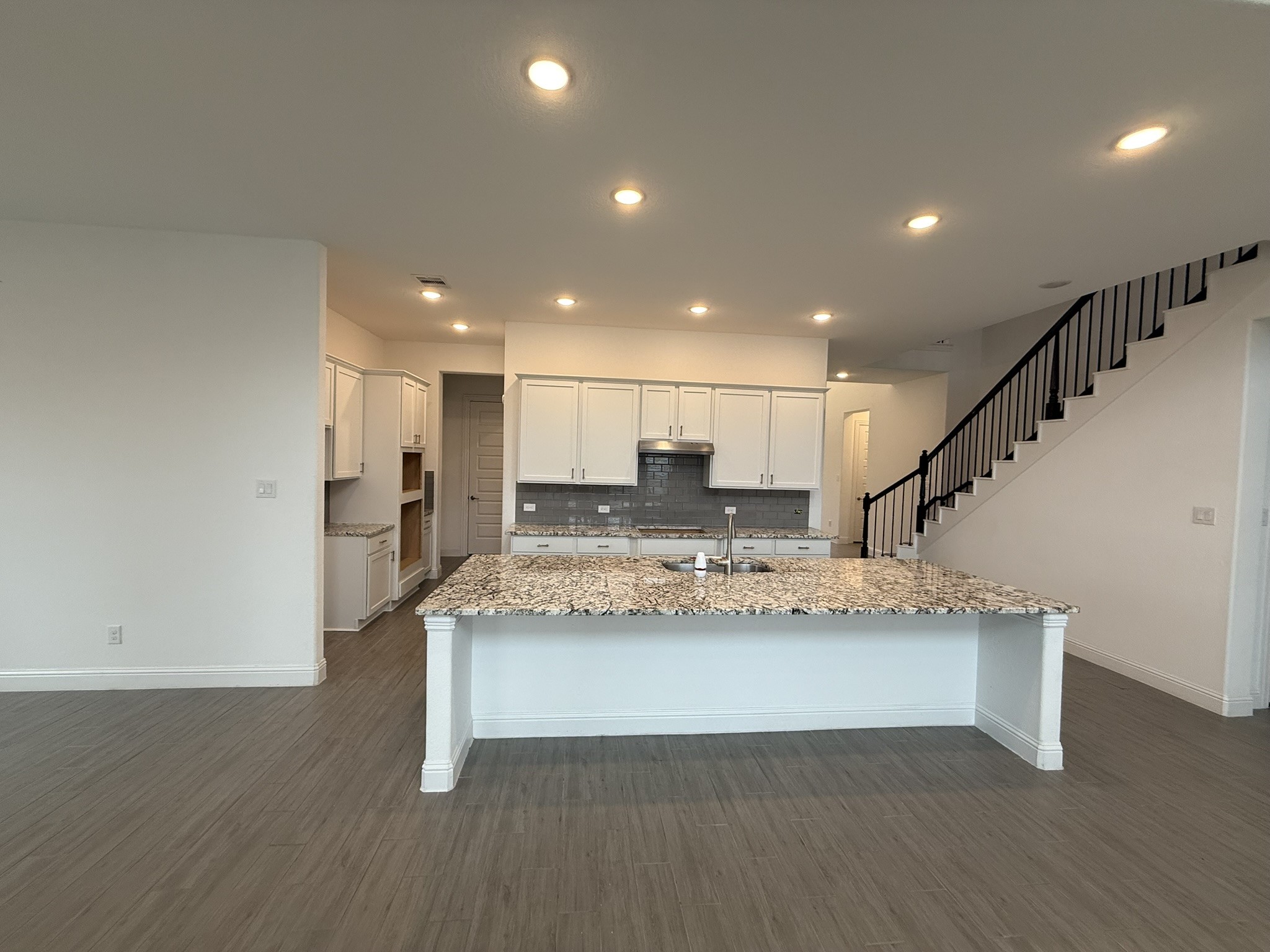 7802 Wayman Pass Fulshear, TX 77441 - Photo 9 of 50 a view of kitchen with kitchen island a sink and a stove