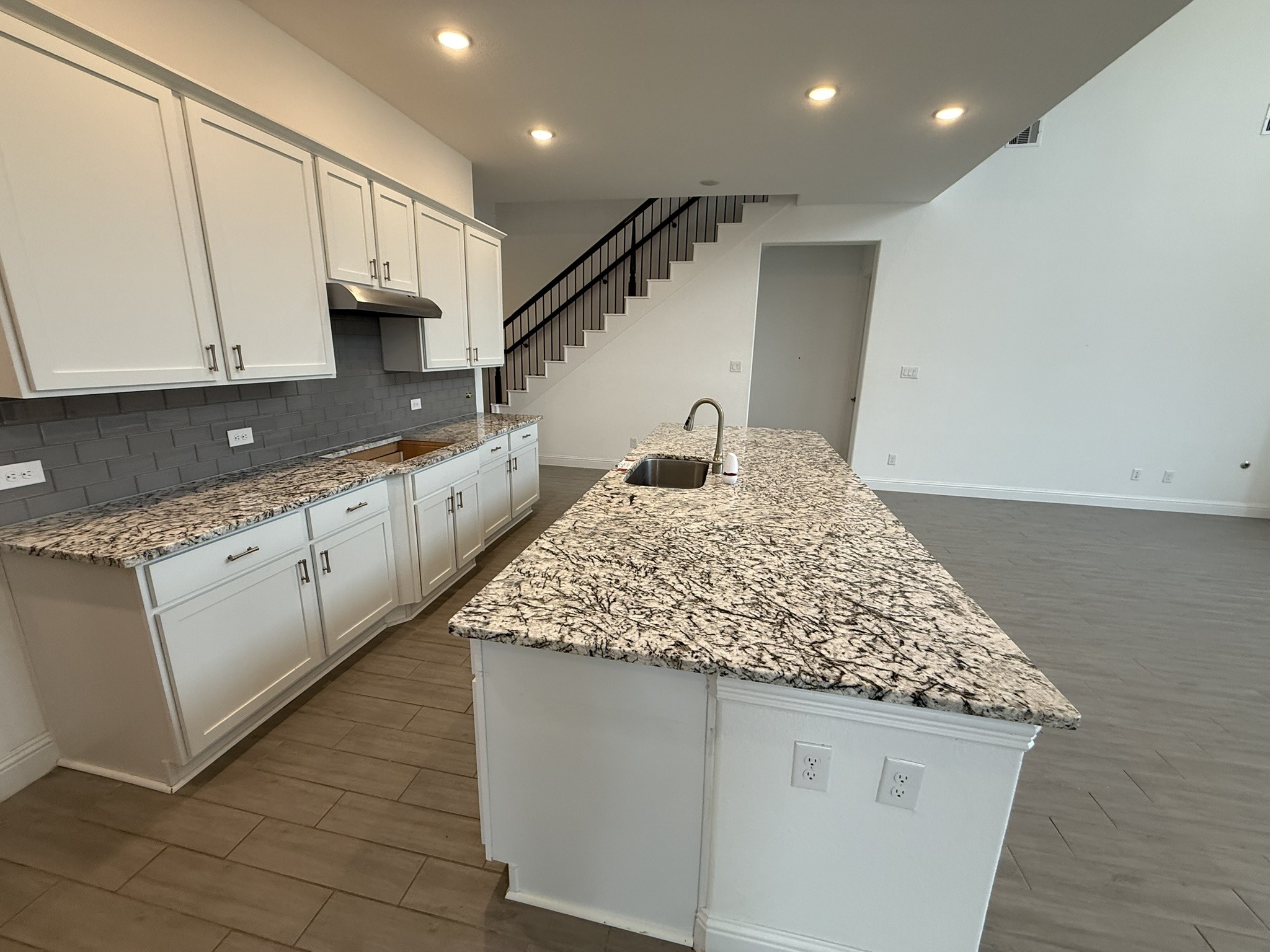7802 Wayman Pass Fulshear, TX 77441 - Photo 10 of 50 a kitchen with stainless steel appliances granite countertop a sink and cabinets