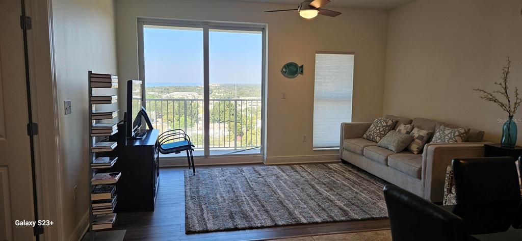 628 Cleveland Street, Unit 1207 Clearwater, FL 33755 - Photo 13 of 36 a living room with furniture and a large window