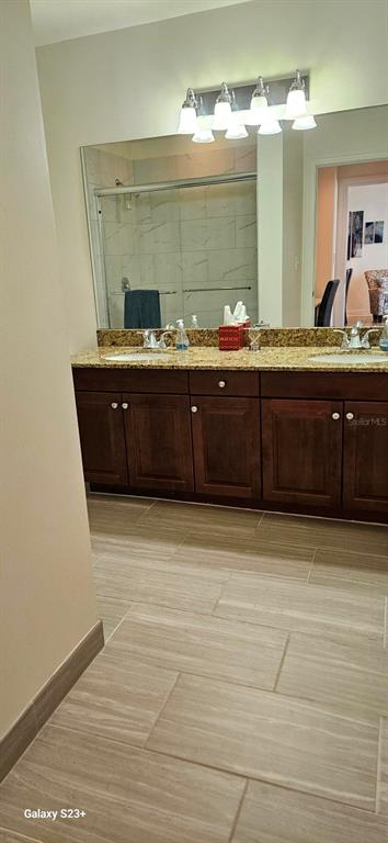 628 Cleveland Street, Unit 1207 Clearwater, FL 33755 - Photo 18 of 36 a bathroom with a sink and a mirror