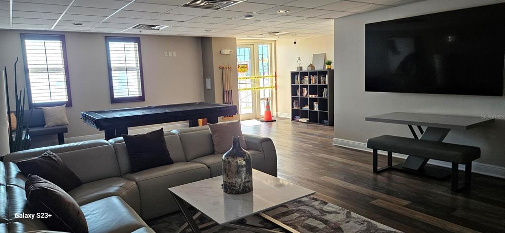 628 Cleveland Street, Unit 1207 Clearwater, FL 33755 - Photo 33 of 36 a living room with furniture and a flat screen tv