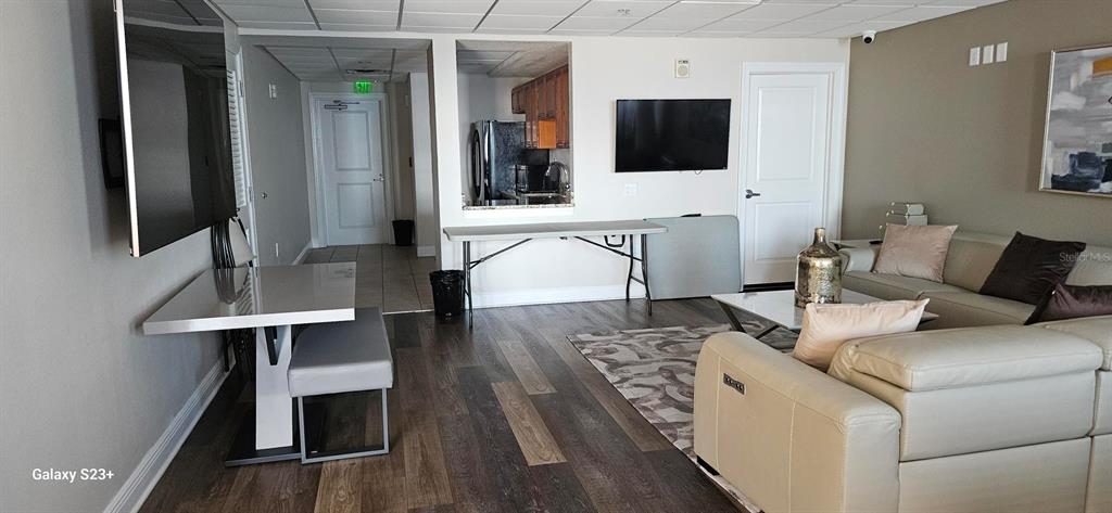 628 Cleveland Street, Unit 1207 Clearwater, FL 33755 - Photo 34 of 36 a living room with furniture and a flat screen tv