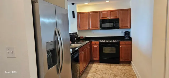 a view of kitchen with a sink and a microwave