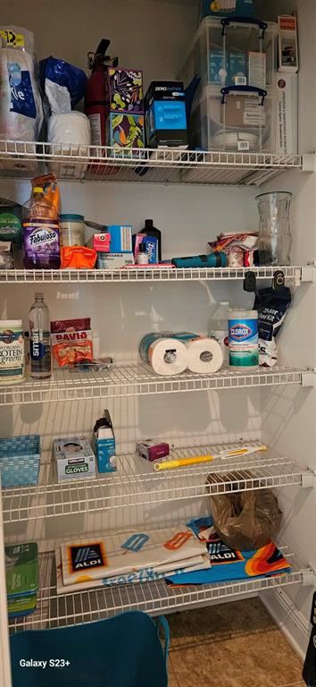 628 Cleveland Street, Unit 1207 Clearwater, FL 33755 - Photo 9 of 36 a shelf with water heater and wooden floor