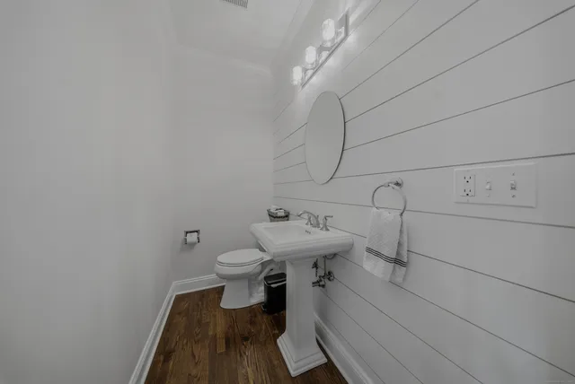 a bathroom with a sink a toilet and vanity