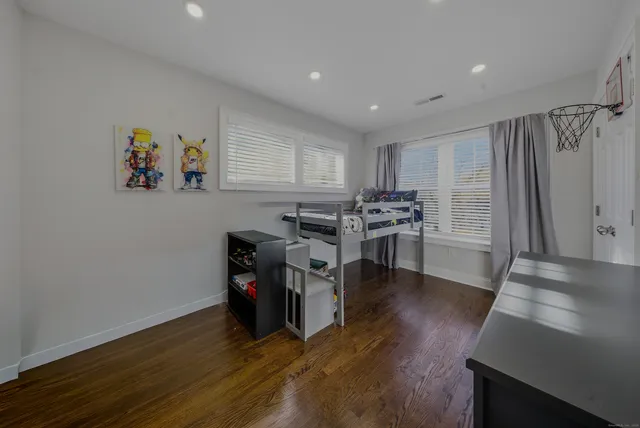 a view of a kitchen with furniture and wooden floor