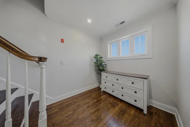 a room with wooden floors and white walls