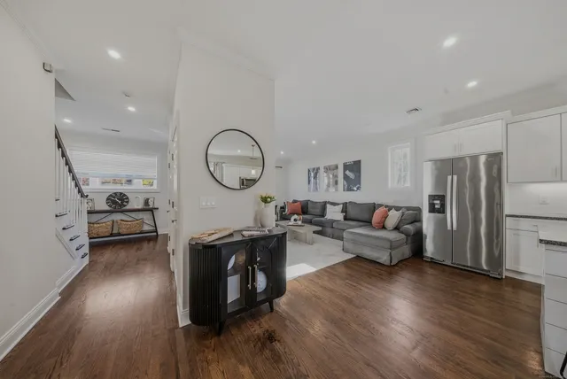 a living room with fireplace furniture and a wooden floor