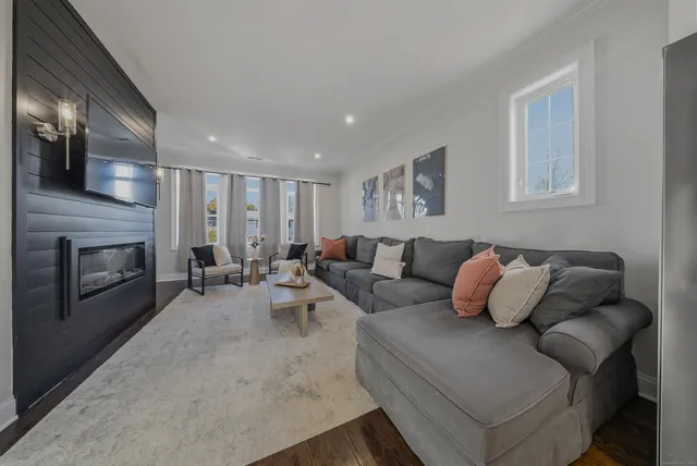 a living room with furniture fireplace and flat screen tv