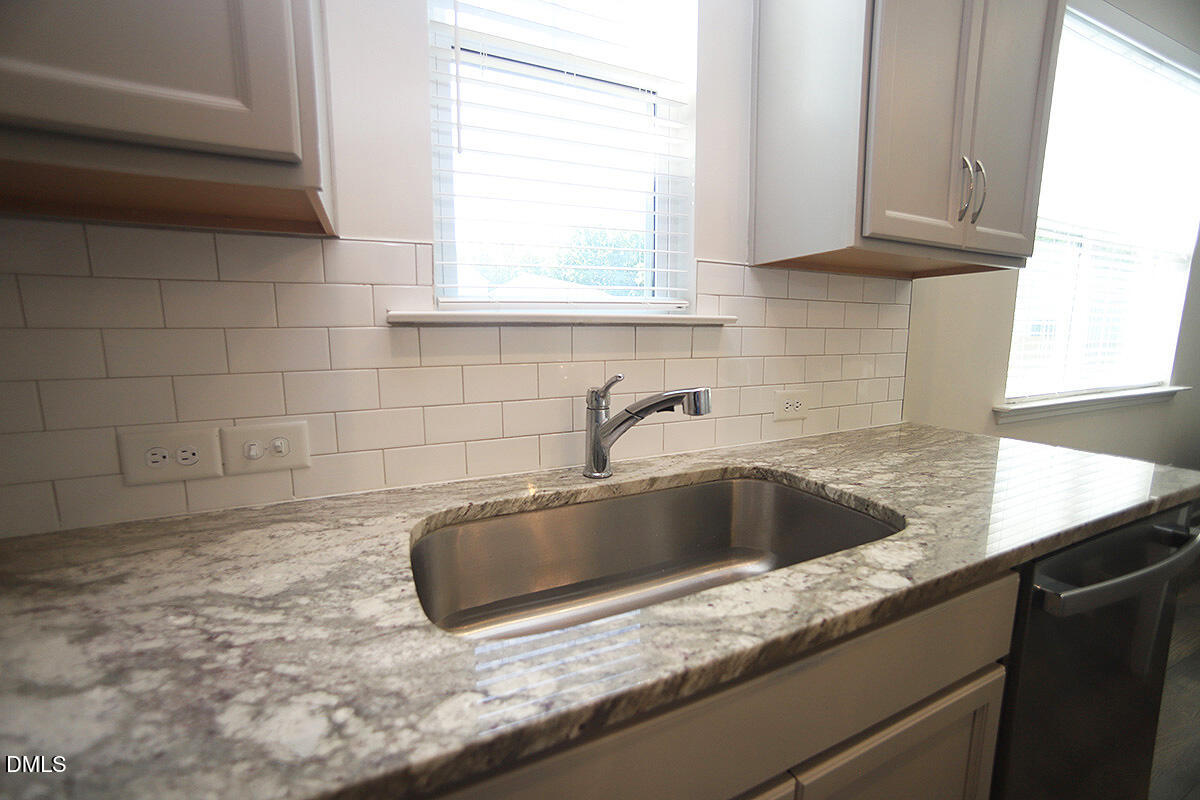 125 Mae Court Roxboro, NC 27573 - Photo 8 of 30 a view of a kitchen counter top a sink and cabinets