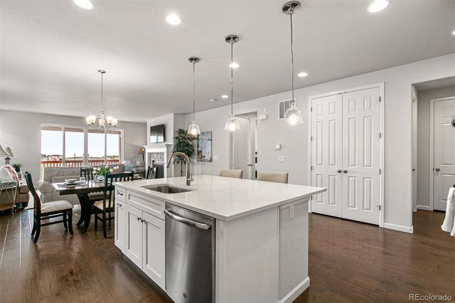 a kitchen with center island table and chairs