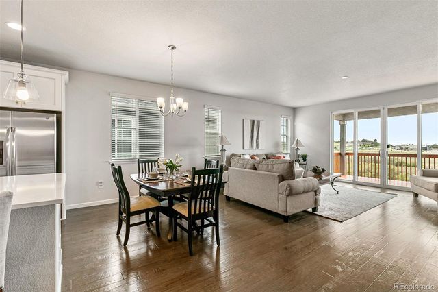 a dining room with furniture window and wooden floor