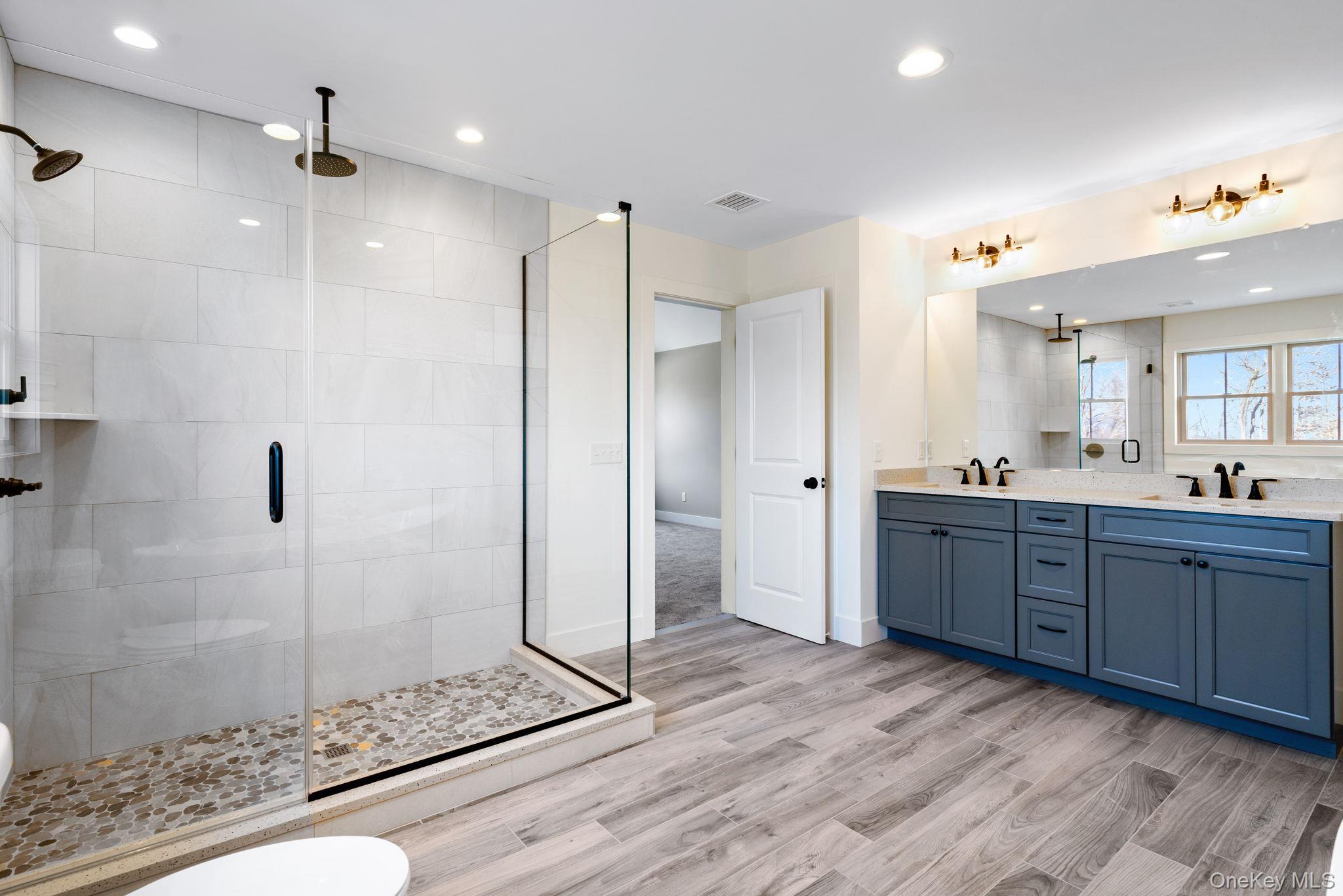13 Harrier Ridge Drive Wallkill, NY 12589 - Photo 23 of 40 Bathroom featuring double vanity, a stall shower, recessed lighting, and light wood-style floors