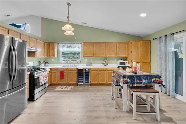 a kitchen with stainless steel appliances granite countertop a stove refrigerator sink and cabinets
