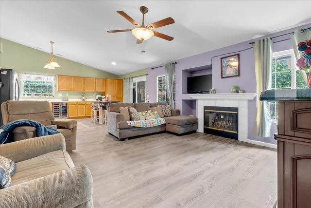 a living room with furniture a fireplace and a flat screen tv