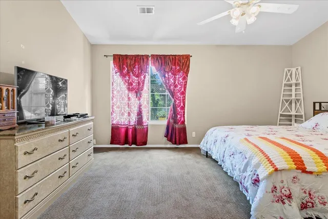 a bedroom with a bed and a dresser