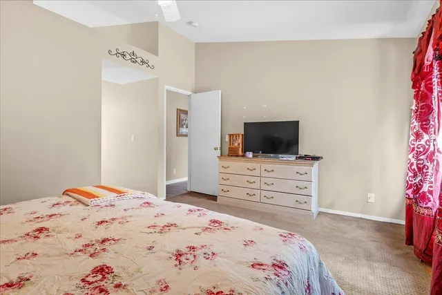 a bedroom with a bed and flat screen tv