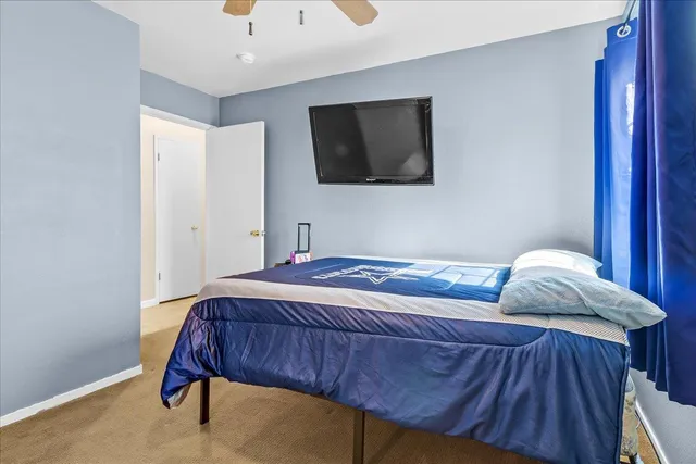 a bedroom with a bed and flat screen tv