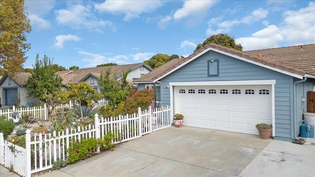a view of a house with wooden fence