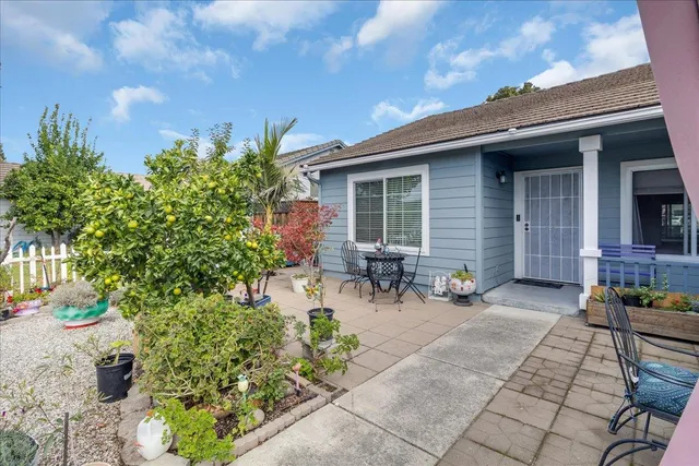 a view of a backyard with sitting area and garden