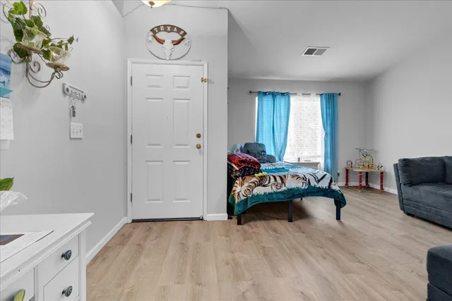 a view of a livingroom with furniture and hardwood floor