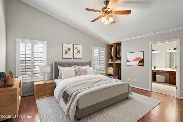 a spacious bedroom with a bed and a chandelier