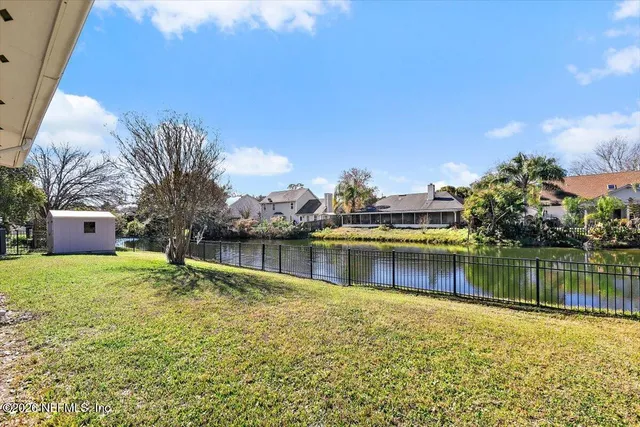 a view of a backyard with a lake view