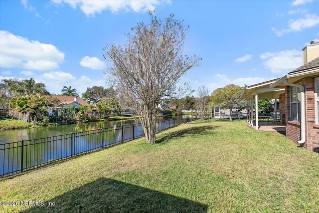 a view of a lake with a house in the background