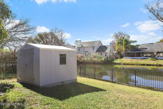 a view of a lake with houses in the back