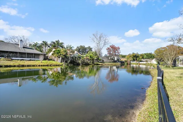 a front view of a house with a garden and yard