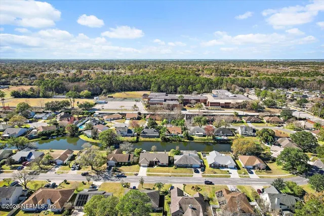 an aerial view of a house with a lake view