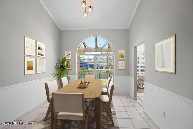 a view of a dining room with furniture a chandelier and wooden floor
