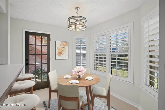 a view of a dining room with furniture window and outside view
