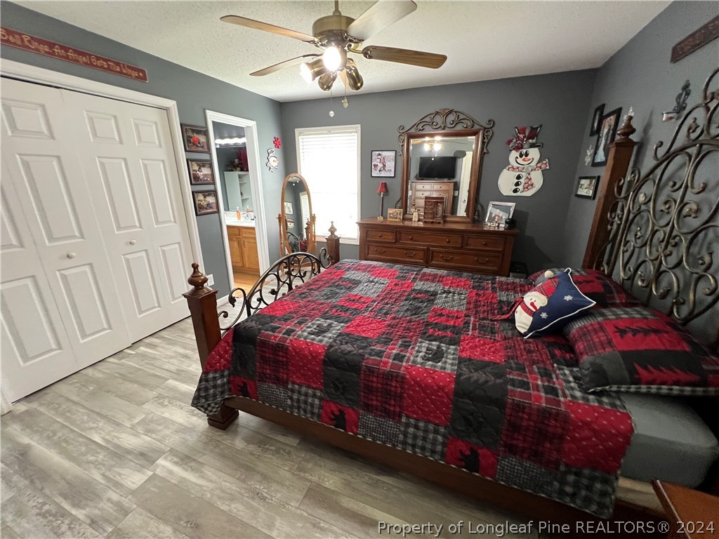 2196 Post Office Road Sanford, NC 27330 - Photo 14 of 21 a bedroom with a bed and a chandelier
