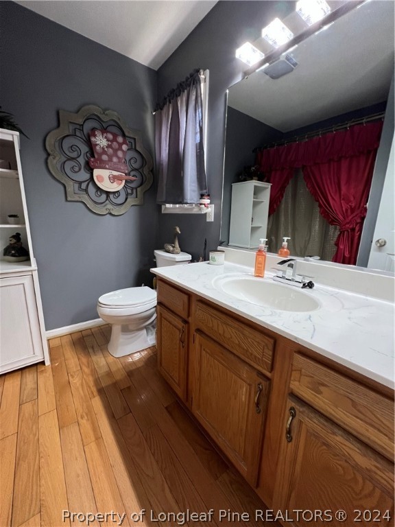 2196 Post Office Road Sanford, NC 27330 - Photo 15 of 21 a bathroom with a sink a toilet a mirror and vanity