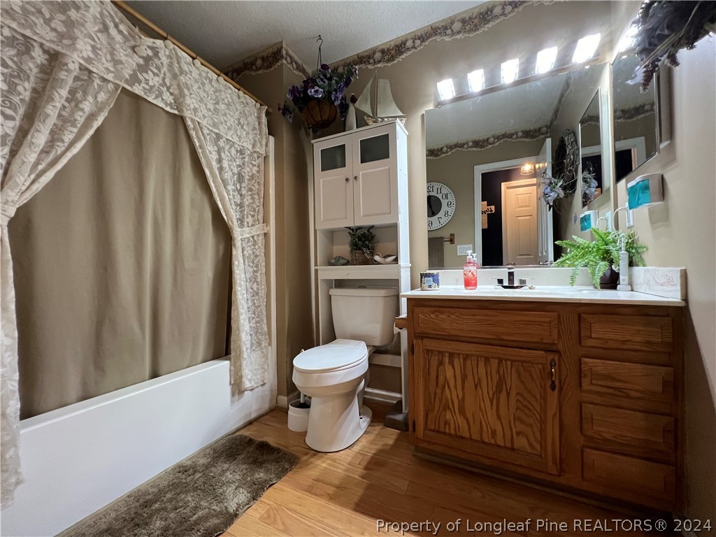 2196 Post Office Road Sanford, NC 27330 - Photo 17 of 21 a bathroom with a sink a toilet and shower