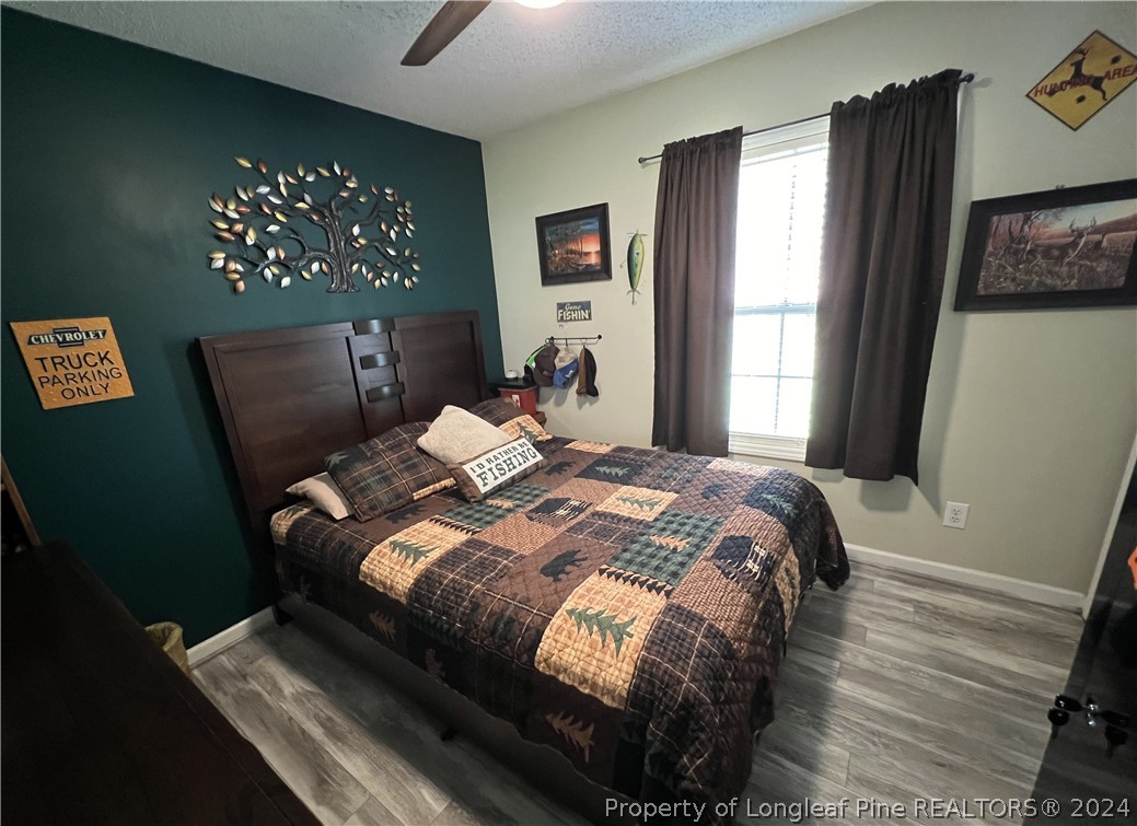 2196 Post Office Road Sanford, NC 27330 - Photo 18 of 21 a bed sitting in a bedroom next to a window