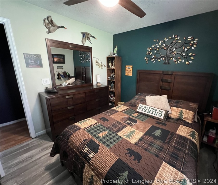 2196 Post Office Road Sanford, NC 27330 - Photo 19 of 21 a bed sitting in a bedroom next to a window