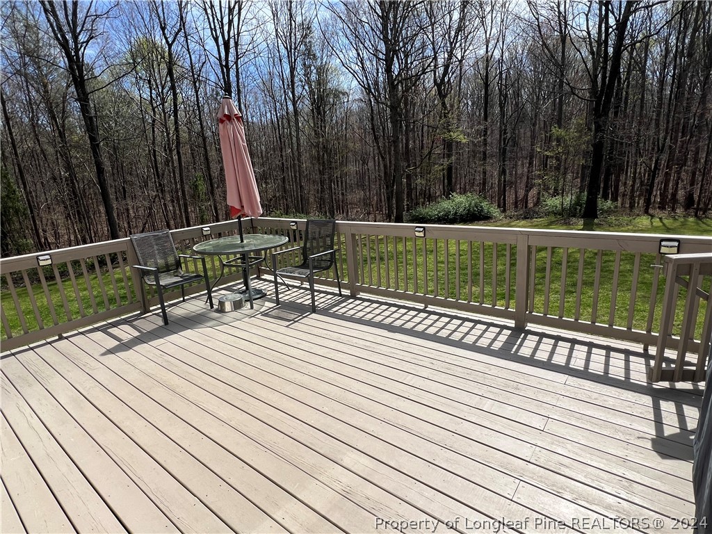 2196 Post Office Road Sanford, NC 27330 - Photo 20 of 21 a view of a wooden deck with a bench