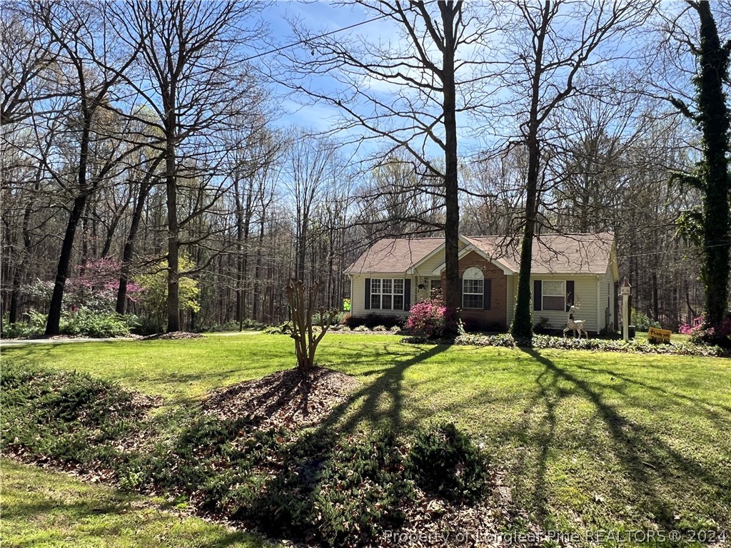 2196 Post Office Road Sanford, NC 27330 - Photo 2 of 21 a yellow house in middle of a field
