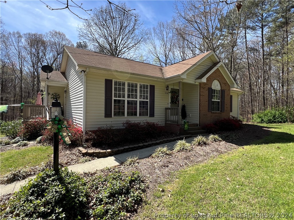 2196 Post Office Road Sanford, NC 27330 - Photo 3 of 21 a front view of a house with a yard