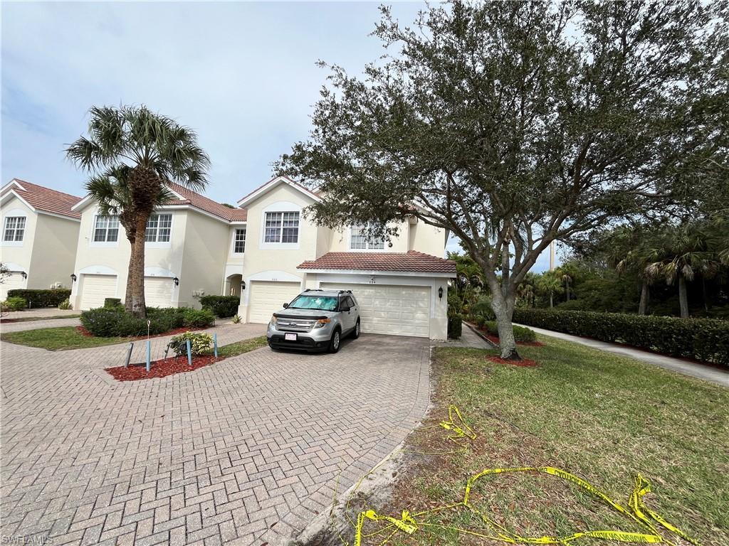 884 Hampton Circle, Unit 159 Naples, FL 34105 - Photo 2 of 28 a view of a house with outdoor space and sitting area
