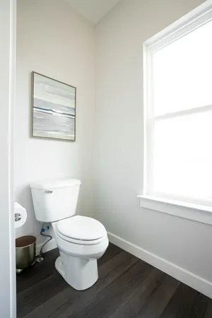 a white toilet sitting next to a bathroom sink