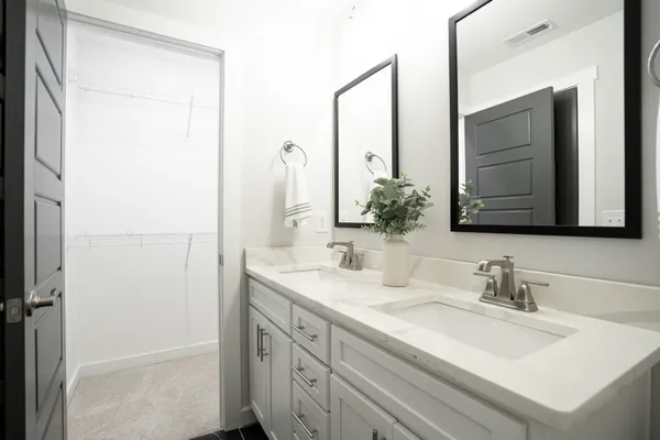 a bathroom with a toilet sink a mirror and shower