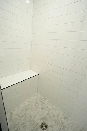 a bathroom with a double vanity sink mirror and shower