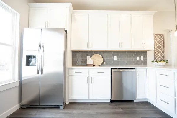 a kitchen with a refrigerator and a stove