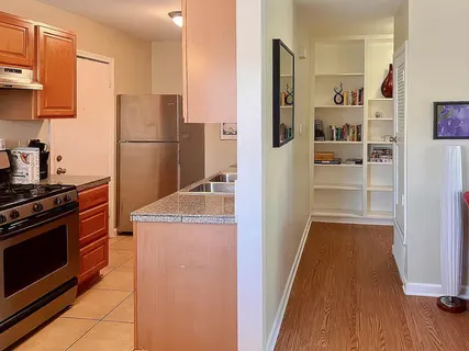 a kitchen with a refrigerator and a stove
