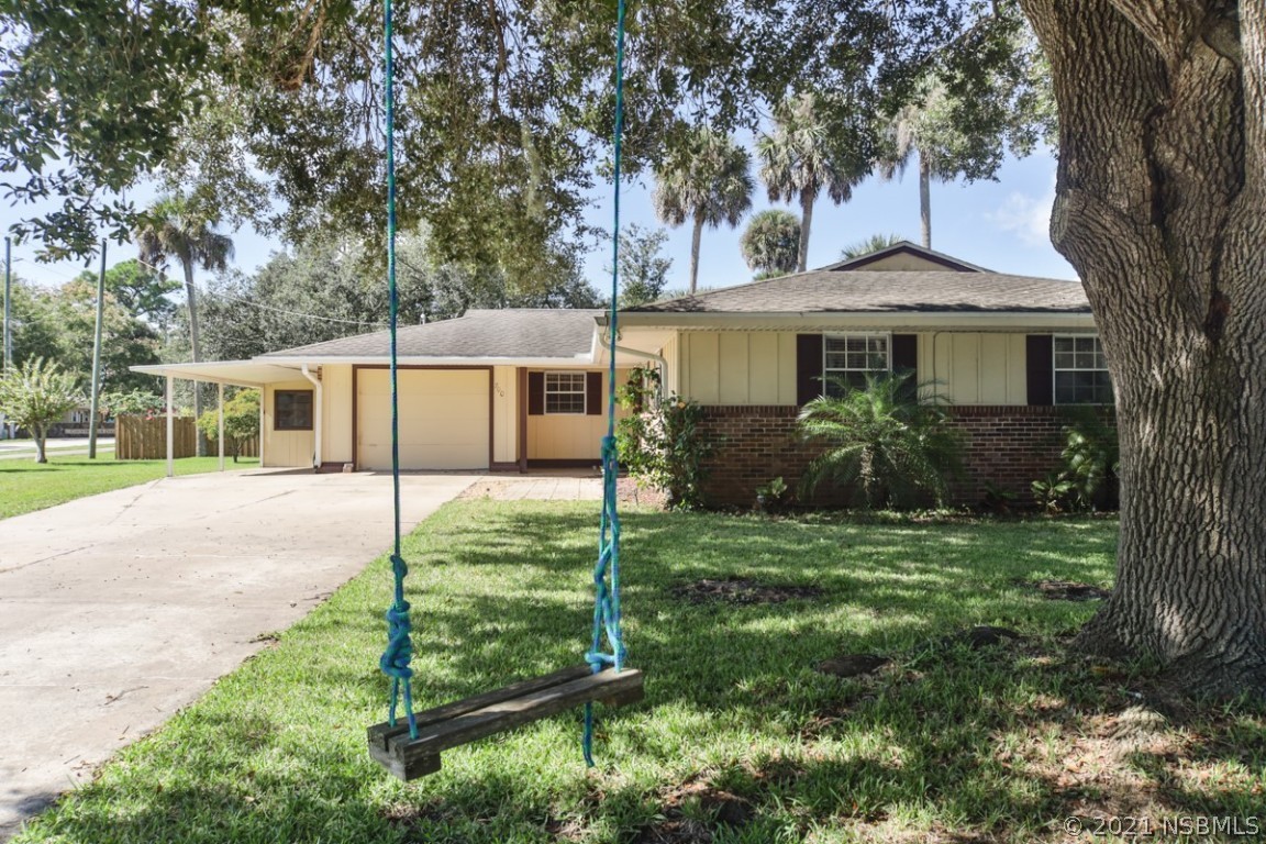 700 Green Road New Smyrna Beach, FL 32168 - Photo 1 of 37 a view of a house with backyard and a tree